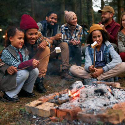 Two happy families enjoying in camping trip while roasting marshmallows on campfire in the woods. Friday Campfire: Spring Bird Migration